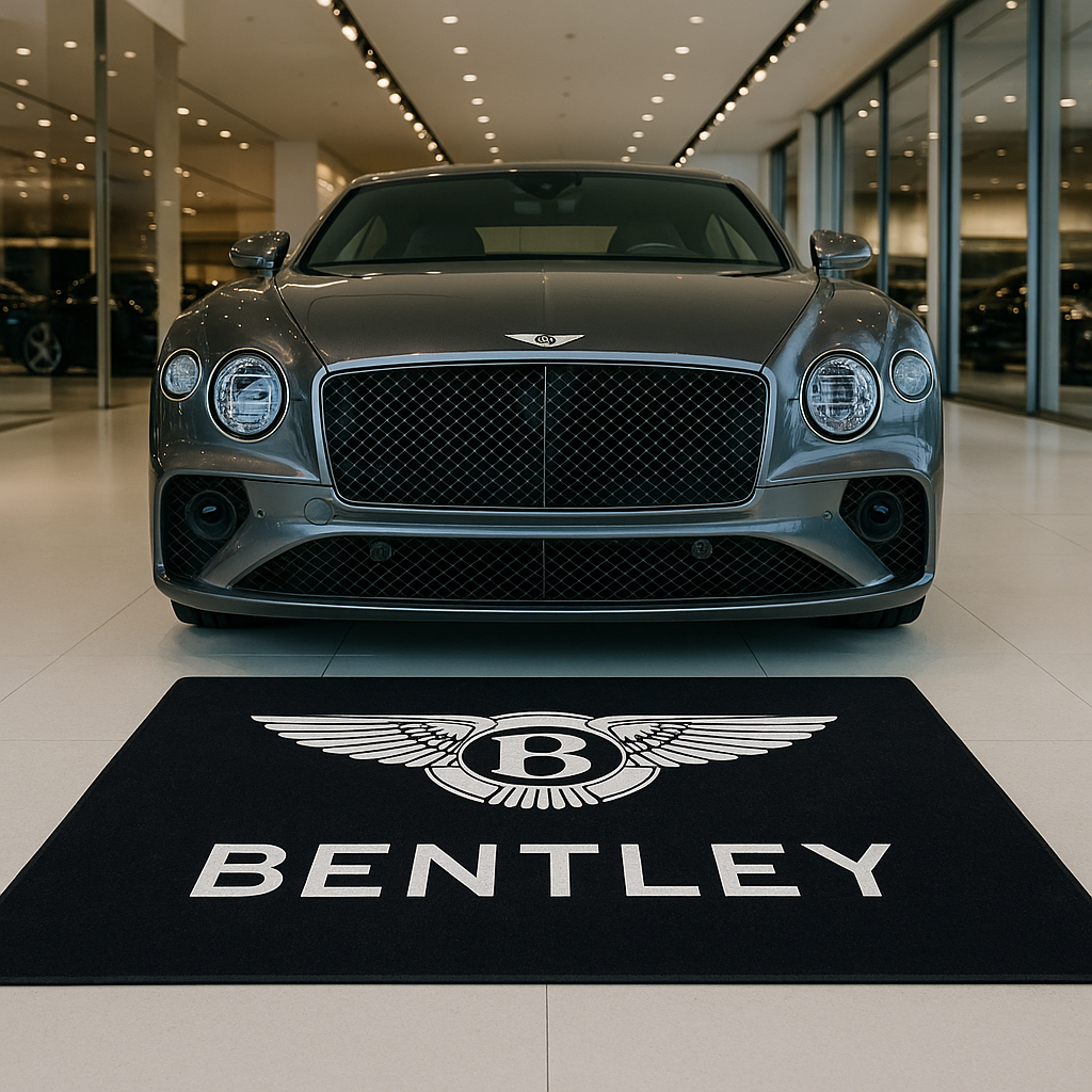 Premium Bentley wings logo floor rug, 150x220cm (approx. 5x7ft), with anti-slip backing displayed in a luxury British car showroom.